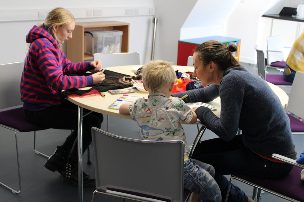Children take part in an upcycling activity with their mum